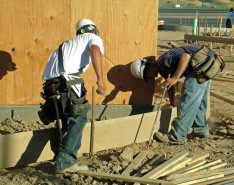 Construction workers pour concrete on the jobsite