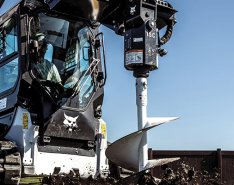Bobcat T66 compact track loader with auger attachment