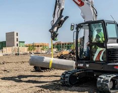 Bobcat excavator moving material on jobsite