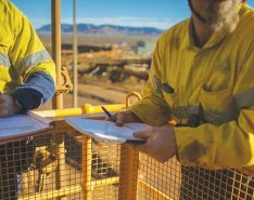 Construction workers completing paperwork on jobsite