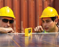 Two construction workers working together