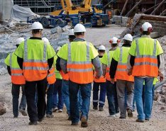 A group of construction workers walking to a jobsite to illustrate a strong workforce