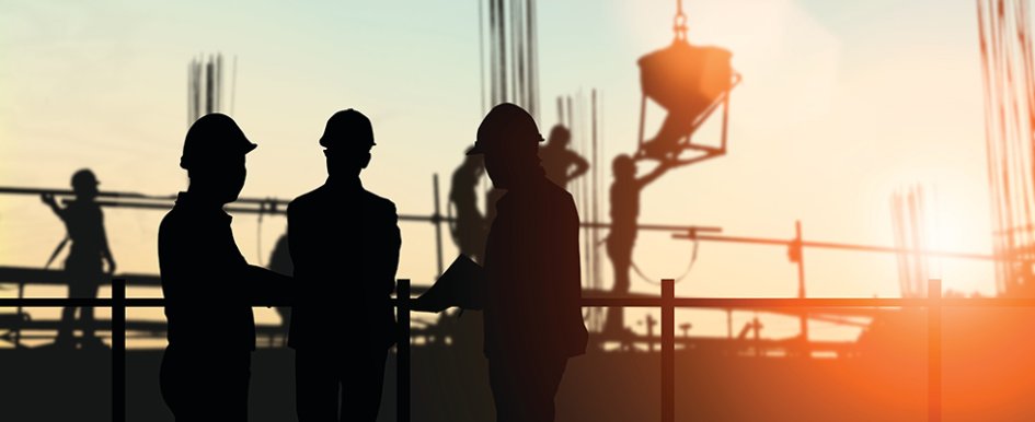 silhouettes of construction workers on site