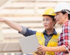 Two women in hard hats/Adobe Stock