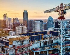 Construction equipment over city/Adobe Stock