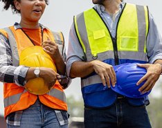 hands and helmets/Adobe Stock