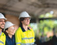 People in hard hats and vests/ Adobe Stock